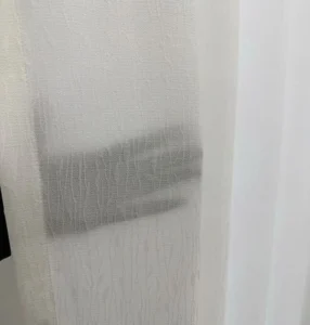 Close up of polyester slub linen sheer fabric showing breathable weave