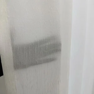 Close up of polyester slub linen sheer fabric showing breathable weave