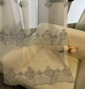 Close up of luxury jacquard sheer fabric with intricate bottom embroidery from a premium B2B supplier