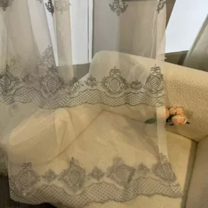 Close up of luxury jacquard sheer fabric with intricate bottom embroidery from a premium B2B supplier