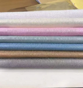 Color swatches of cross-textured solid sheer voile fabric available in bulk rolls