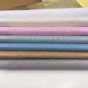 Color swatches of cross-textured solid sheer voile fabric available in bulk rolls