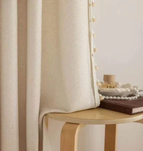 Close-up showing the excellent drape of heavyweight sheer curtain fabric, manufactured for luxury hotel projects.