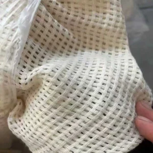 Wholesale open weave sheer curtain fabric with cotton look, supplied by direct manufacturer for B2B projects.